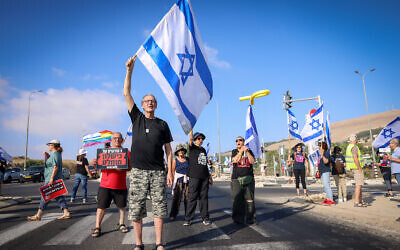 Protesters stand on the road during a 'day of disruption' anti-government protest marking nine months since the October 7 massacre, at the Rosh Pina junction in northern Israel, July 7, 2024. (David Cohen/Flash90)