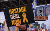 Demonstrators protest for the release of  hostages in the Gaza Strip, outside the Kirya military headquarters in Tel Aviv, July 7, 2024. Einav Zangauker, the mother of hostage Matan Zangauker, is standing in the cage at left. The slogan on the cage reads, 'Netanyahu, it's in your hands.' (Itai Ron/ Flash90