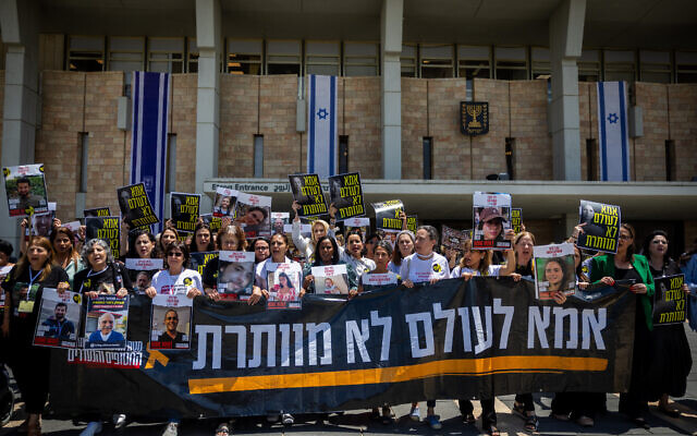 Mothers of Israelis held hostage by Hamas terrorists in Gaza, activists and MKs protest for their release at the Knesset in Jerusalem, July 8, 2024. Banner reads 'A mother never gives up.' (Yonatan Sindel/Flash90)