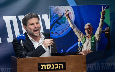 Finance Minister and head of the Religious Zionist Party Bezalel Smotrich holds up a picture of Gaza Hamas leader Yahya Sinwar while arguing against a ceasefire in Gaza during a faction meeting at the Knesset in Jerusalem, on July 8, 2024.(Yonatan Sindel/Flash90) Finance Minister and head of the Religious Zionist Party Bezalel Smotrich holds up a picture of Gaza Hamas leader Yahya Sinwar while arguing against a ceasefire in Gaza during a faction meeting at the Knesset in Jerusalem, on July 8, 2024.(Yonatan Sindel/Flash90)