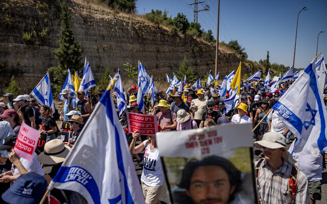 Relatives of Israelis held hostage by Hamas terrorists in Gaza and supporters march on Route 1 towards Jerusalem, as part of a protest for their release, July 12, 2024. (Yonatan Sindel/Flash90) Relatives of Israelis held hostage by Hamas terrorists in Gaza and supporters march on Route 1 towards Jerusalem, as part of a protest for their release, July 12, 2024. (Yonatan Sindel/Flash90)