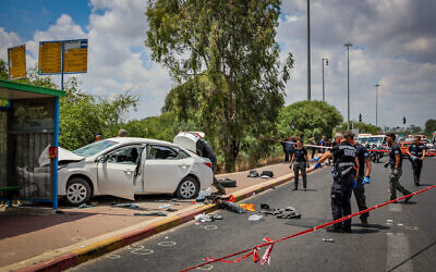 Israeli security and rescue personnel at the scene of a terror attack at the Nir Tzvi Junction in central Israel, on July 14, 2024. (Yossi Aloni/Flash90)