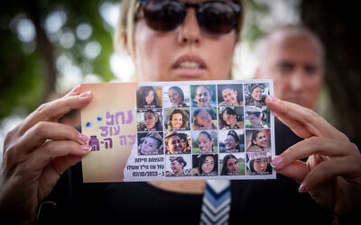 Families of Israeli surveillance soldiers who were killed by Hamas terrorists at the Nahal Oz surveillance outpost on October 7, 2023, hold up photographs of the soldiers and speak to the press after meeting with Prime Minister Benjamin Netanyahu, outside the Prime Minister's Office in Jerusalem, July 17, 2024. (Yonatan Sindel/ Flash90)