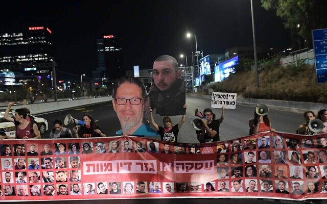 Relatives of Israelis held hostage by Hamas terrorists in Gaza and their supporters block the Ayalon Highway and call for a deal to release their loved ones, in Tel Aviv, July 23, 2024. (Tomer Neuberg/Flash90) Relatives of Israelis held hostage by Hamas terrorists in Gaza and their supporters block the Ayalon Highway and call for a deal to release their loved ones, in Tel Aviv, July 23, 2024. (Tomer Neuberg/Flash90)