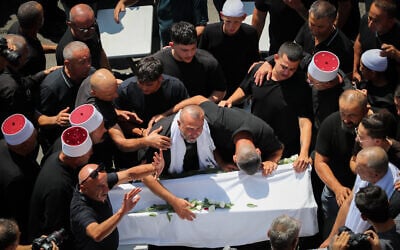Family and friends attend the funeral service of Druze children who were killed at a soccer field from a missile fired from Lebanon, in the Druze village of Majdal Shams, in the Golan Heights, July 28, 2024. (Jamal Awad/Flash90)
