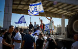 Far-right protesters rally before storming the Sde Teiman military detention facility in southern Israel following the arrest of nine reservists accused of sexually abusing a Palestinian inmate there, on July 29, 2024. (Dudu Greenspan/Flash90)