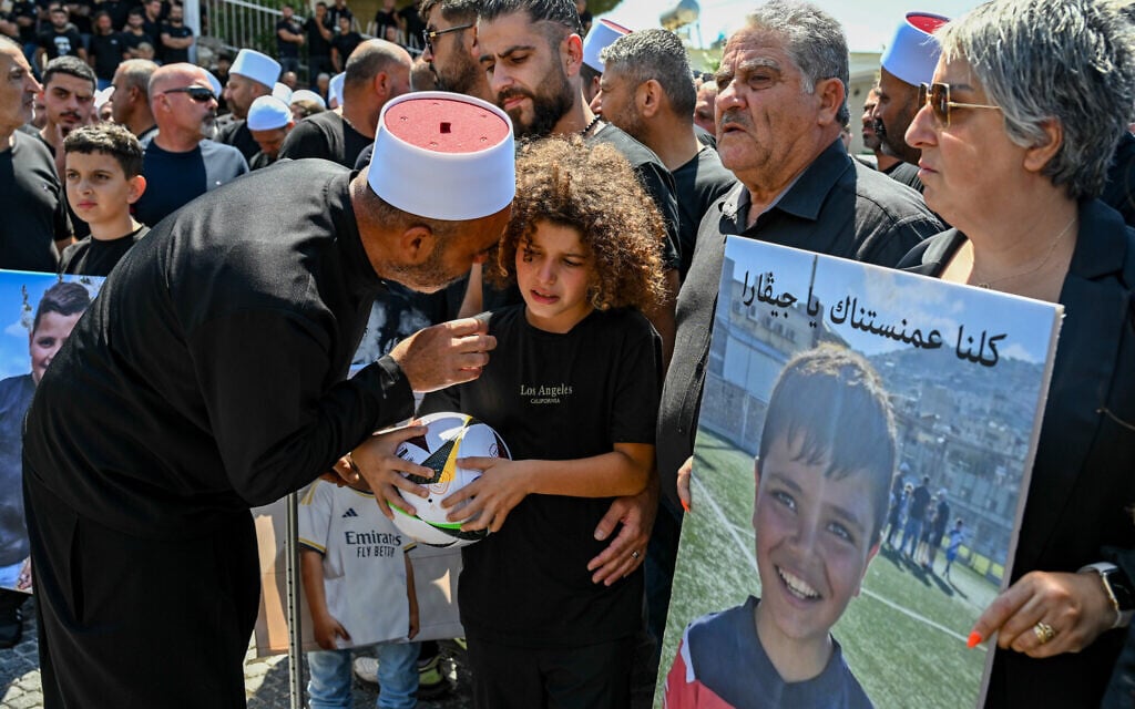 Family and friends attend the funeral service of Gevara Ebraheem, 11, one of 12 children killed at a soccer field from a missile fired by terrorists in Lebanon two days ago, in the Druze village of Majdal Shams, in the Golan Heights, July 29, 2024. (Michael Giladi/Flash90)