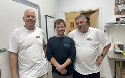 Dagan Peleg (left), Tom Carbone and Yaakov Benacot (right) of Be'eri Dairy on June 27, 2024, still in recovery from October 7 (Jessica Steinberg/Times of Israel)