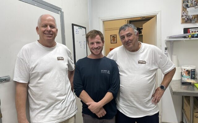 Dagan Peleg (left), Tom Carbone and Yaakov Benacot (right) of Be'eri Dairy on June 27, 2024, still in recovery from October 7 (Jessica Steinberg/Times of Israel)