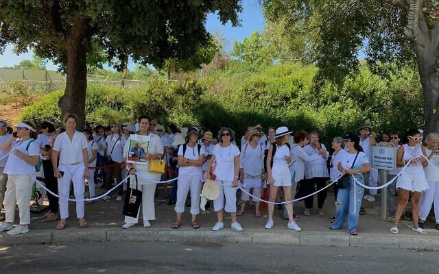 Women dressed all in white demonstrate for a hostage deal and an end to the Israel-Hamas war outside the Knesset in Jerusalem on July 2, 2024. (Charlie Summers/Times of Israel)
