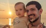 Or Levy, left, and his young son, Almog, now three, before Or Levy was taken hostage on October 7, 2023 from a bomb shelter near the Supernova desert rave, where his wife, Eynav Levy, was killed by Hamas terrorists (Courtesy)