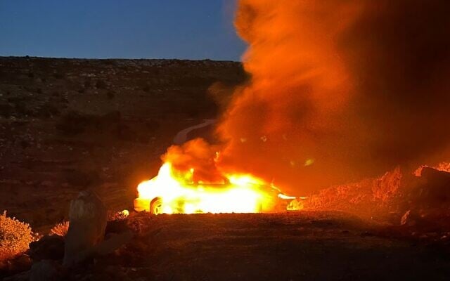A vehicle burns as settlers attack Civil Administration and Border Police personnel involved in demolishing the illegal West Bank outpost Tzur Harel, July 3, 2024 (Civil Administration) A vehicle burns as settlers attack Civil Administration and Border Police personnel involved in demolishing the illegal West Bank outpost Tzur Harel, July 3, 2024 (Civil Administration)