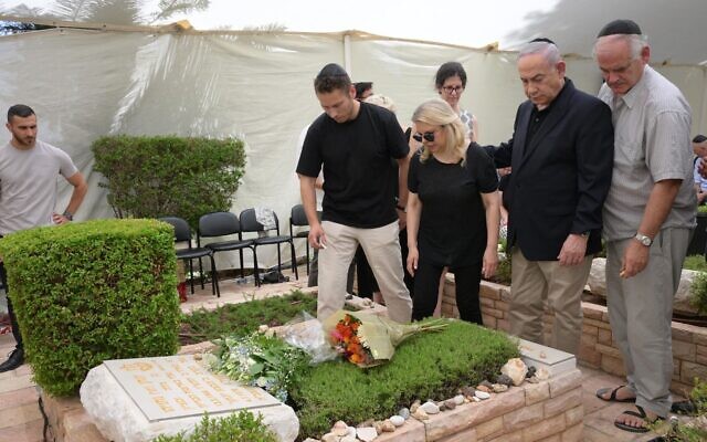 Prime Minister Benjamin Netanyahu (2nd right) is joined by family and friends at a memorial for his brother Yonatan, who was killed in the operation to free Israeli hostages at Entebbe, at Mount Herzl military cemetery, Jerusalem, June 5, 2024. (Amos Ben Gershom/GPO)