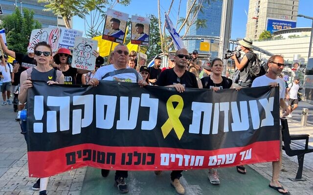 Families of hostages set out on the first leg of a four-day march from Tel Aviv to Jerusalem to call for a hostage deal, July 10, 2024. Banner reads 'March to a deal.' (Yael Gadot/Pro-Democracy Protest Movement) Families of hostages set out on the first leg of a four-day march from Tel Aviv to Jerusalem to call for a hostage deal, July 10, 2024. Banner reads 'March to a deal.' (Yael Gadot/Pro-Democracy Protest Movement)