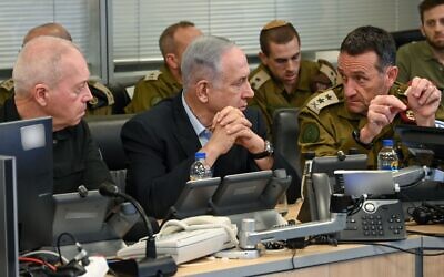 From left: Defense Minister Yoav Gallant, Prime Minister Benjamin Netanyahu and IDF Chief of Staff Herzi Halevi follow Israel's strike in Yemen from the IAF operations room at the Kirya Headquarters in Tel Aviv, July 20, 2024. (Ariel Hermoni/Defense Ministry)