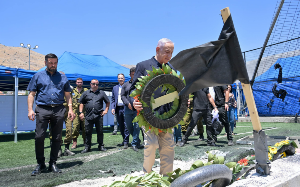 Prime Minister Benjamin Netanyahu lays a wreath at the site of a deadly rocket attack in Majdal Shams, July 29, 2024. (Kobi Gideon/GPO)