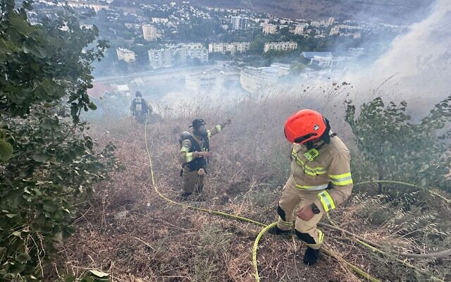 Firefighters battle a brush fire sparked by Hezbollah rockets near Kiryat Shmona on July 2, 2024. (Fire and Rescue Service) Firefighters battle a brush fire sparked by Hezbollah rockets near Kiryat Shmona on July 2, 2024. (Fire and Rescue Service)