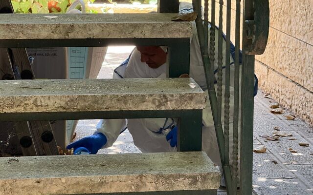 Forensic officers working at the scene where an Israel Prison Service officer was found dead in his home in the West Bank settlement Givon Hahadasha, July 8, 2024. (Israel Police) Forensic officers working at the scene where an Israel Prison Service officer was found dead in his home in the West Bank settlement Givon Hahadasha, July 8, 2024. (Israel Police)