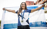 Israeli windsurfer Sharon Kantor poses for a photo with her silver Olympic medal in Paris on August 4, 2024. (Olympic Committee of Israel)