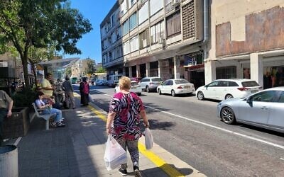 Illustrative: A woman carries her shopping near Talpiot Market in Haifa on August 4, 2024. (Canaan Lidor/Times of Israel) Illustrative: A woman carries her shopping near Talpiot Market in Haifa on August 4, 2024. (Canaan Lidor/Times of Israel)