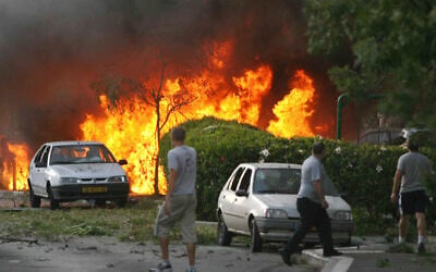 FILE: Cars burn in Haifa following a rocket attack by Hezbollah terrorists, August 13, 2006. (Roni Schutzer / AFP)