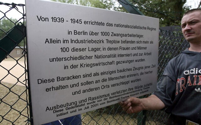 Illustrative: Workers put up a commemorative plaque outside barracks formerly used to house forced laborers now turned into a memorial and museum documenting Nazi Germany´s widespread use of forced labor in Berlin´s Schoeneweide district 24 August 2006. (Photo by JOHN MACDOUGALL / AFP) Illustrative: Workers put up a commemorative plaque outside barracks formerly used to house forced laborers now turned into a memorial and museum documenting Nazi Germany´s widespread use of forced labor in Berlin´s Schoeneweide district 24 August 2006. (Photo by JOHN MACDOUGALL / AFP)