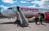 Passengers disembark from an aircraft of Spanish low-cost airline Iberia Express at Berlin Brandenburg Airport Willy Brandt (BER) in Schoenefeld, southeast of the German capital on July 16, 2022. (John MacDougall / AFP)