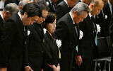 Eighty-five-year-old atomic bombing survivor Takeko Kudo (3rd L) and other representatives observe a moment of silence at the time of the bombing at 11:02 am during a peace memorial ceremony at an indoor facility due to approaching Typhoon Khanun in Nagasaki, Nagasaki prefecture on August 9, 2023, as the city marks the 78th anniversary of the atomic bombing during World War II. (Photo by JAPAN POOL / JIJI Press / AFP) / Japan OUT / JAPAN OUT