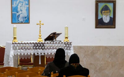 Christian worshippers attend church in the Jish village in northern Israel near the Lebanon border on January 17, 2024. (Jalaa Marey / AFP)
