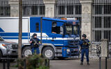 Illustrative: Armed police officers stand outside Swiss National Bank headquarters in Zurich, Switzerland, March 21, 2024. (Fabrice Coffrini / AFP)