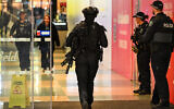 Heavily armed police and the Star Force stand guard at the entrance to the Westfield Marion shopping centre in suburban Adelaide on June 23, 2024 (MICHAEL ERREY / AFP)