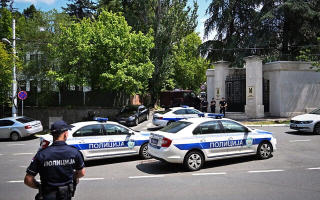 Police cars and officers are stationed on a street around the Israeli embassy in Belgrade, on June 29, 2024, after a man wielding a crossbow shot and wounded a police officer guarding the embassy, and was then fatally shot by the officer. (Oliver Bunic/AFP) Police cars and officers are stationed on a street around the Israeli embassy in Belgrade, on June 29, 2024, after a man wielding a crossbow shot and wounded a police officer guarding the embassy, and was then fatally shot by the officer. (Oliver Bunic/AFP)