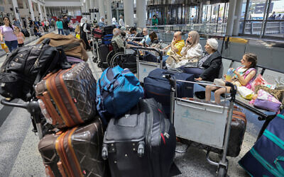 Passengers wait at Rafic Hariri International Airport after their flights were delayed or cancelled in Beirut on July 29, 2024. (Anwar AMRO / AFP)