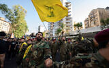Hezbollah operatives form a human barrier during the funeral procession of slain top Hezbollah military commander Fuad Shukr in Beirut's southern suburbs on August 1, 2024. (Khaled Desouki/AFP)