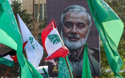 A portrait of slain Hamas leader Ismail Haniyeh is displayed during a demonstration denouncing his killing and that of Hezbollah's senior commander Fuad Shukr, in the Lebanese coastal city of Sidon, on August 2, 2024. (Mahmoud Zayyat / AFP)