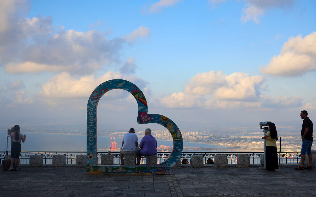 People visit an observation point overlooking the Israeli northern port city of Haifa on August 2, 2024. (Photo by Oren ZIV / AFP)
