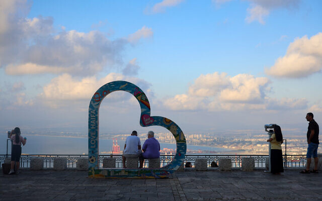 People visit an observation point overlooking the Israeli northern port city of Haifa on August 2, 2024. (Photo by Oren ZIV / AFP)