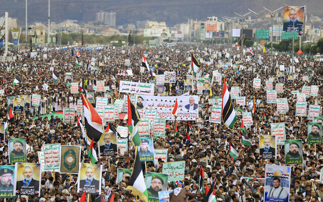 Yemenis wave flags and lift placards showing Hezbollah terror group commander Fuad Shukr, who was killed in an Israeli strike in Beirut, and Hamas terror chief Ismail Haniyeh, killed in Tehran, during a rally in the Houthi-controlled capital Sanaa on August 2, 2024. (Abdallah Adel/AFP) Yemenis wave flags and lift placards showing Hezbollah terror group commander Fuad Shukr, who was killed in an Israeli strike in Beirut, and Hamas terror chief Ismail Haniyeh, killed in Tehran, during a rally in the Houthi-controlled capital Sanaa on August 2, 2024. (Abdallah Adel/AFP)