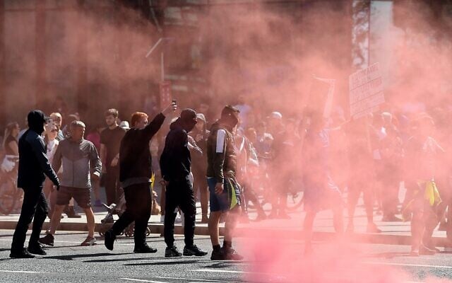 Protesters throw flares towards police officers in Liverpool on August 3, 2024 during the 'Enough is Enough' demonstration held in reaction to the fatal stabbings in Southport on July 29. (Peter Powell/AFP) Protesters throw flares towards police officers in Liverpool on August 3, 2024 during the 'Enough is Enough' demonstration held in reaction to the fatal stabbings in Southport on July 29. (Peter Powell/AFP)