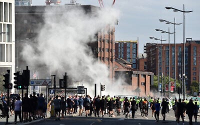 Smoke billows as police officers face off protesters in Liverpool on August 3, 2024, during the 'Enough is Enough' demonstration held in reaction to the fatal stabbings in Southport on July 29.(Peter Powell/AFP)