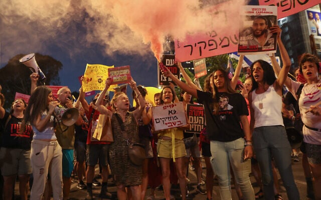 Supporters and relatives of Israelis held hostage in the Gaza Strip since October lift placards during a rally to demand their release in Tel Aviv on August 3, 2024. (GIL COHEN-MAGEN / AFP) Supporters and relatives of Israelis held hostage in the Gaza Strip since October lift placards during a rally to demand their release in Tel Aviv on August 3, 2024. (GIL COHEN-MAGEN / AFP)