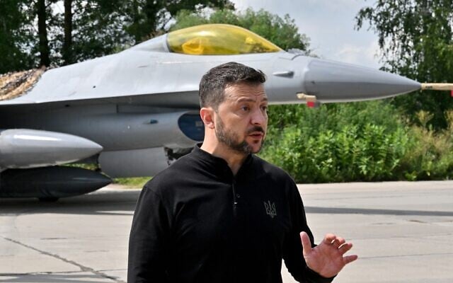 Ukraine's President Volodymyr Zelensky gestures as he speaks to media representatives while standing in front of an F16 fighter jet during Ukrainian Air Forces Day at an undisclosed location on August 4, 2024. (Sergei Supinsky/AFP) Ukraine's President Volodymyr Zelensky gestures as he speaks to media representatives while standing in front of an F16 fighter jet during Ukrainian Air Forces Day at an undisclosed location on August 4, 2024. (Sergei Supinsky/AFP)