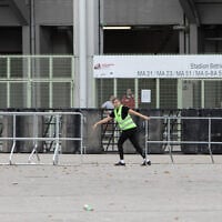 Security guards remove barriers in front of the Ernst Happel Stadium in Vienna, Austria, on August 8, 2024, after the three concerts of US mega-star Taylor Swift were canceled following the arrest of an Islamic State sympathizer in connection with an terror plot. (Alex Halada/AFP)