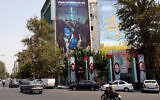 An anti-Israel billboard showing Israeli soldiers running with a slogan in Farsi which reads: 'Laugh a little now, for you will be crying soon,' is seen on a building in Tehran's Palestine square on August 8, 2024. (AFP)
