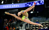 Israel's Daria Atamanov performs with the clubs in the rhythmic gymnastics' individual all-around qualification at the Paris 2024 Olympics, August 8, 2024. (Loic Venance/AFP)