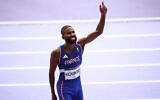 France's Muhammad Abdallah Kounta celebrate after competing in the men's 4x400m relay heat of the athletics event at the Paris 2024 Olympic Games at Stade de France in Saint-Denis, north of Paris, on August 9, 2024. (Anne-Christine Poujoulat / AFP)