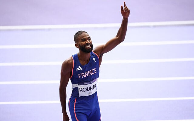 France's Muhammad Abdallah Kounta celebrate after competing in the men's 4x400m relay heat of the athletics event at the Paris 2024 Olympic Games at Stade de France in Saint-Denis, north of Paris, on August 9, 2024. (Anne-Christine Poujoulat / AFP) France's Muhammad Abdallah Kounta celebrate after competing in the men's 4x400m relay heat of the athletics event at the Paris 2024 Olympic Games at Stade de France in Saint-Denis, north of Paris, on August 9, 2024. (Anne-Christine Poujoulat / AFP)