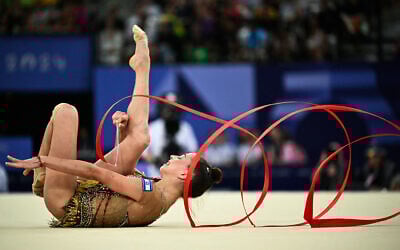 Israel's Daria Atamanov performs with the ribbon in the rhythmic gymnastics' individual all-around final at the Paris 2024 Olympics at the Porte de la Chapelle Arena in Paris, August 9, 2024. (Lionel BONAVENTURE / AFP)