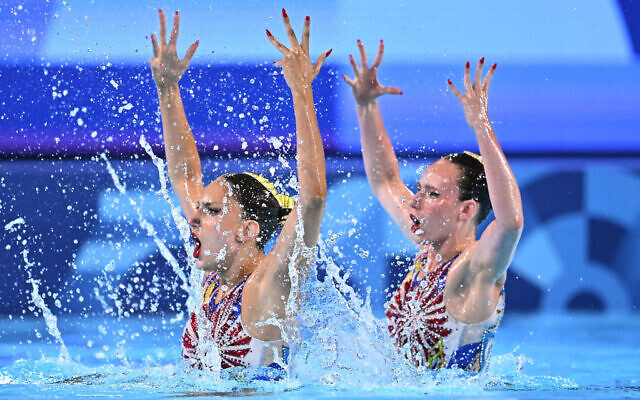 Israel's Ariel Nassee and Shelly Bobritsky compete in the duet technical routine of the artistic swimming event during the Paris 2024 Olympic Games at the Aquatics Centre in Saint-Denis, north of Paris, on August 9, 2024. (Manan VATSYAYANA / AFP) Israel's Ariel Nassee and Shelly Bobritsky compete in the duet technical routine of the artistic swimming event during the Paris 2024 Olympic Games at the Aquatics Centre in Saint-Denis, north of Paris, on August 9, 2024. (Manan VATSYAYANA / AFP)