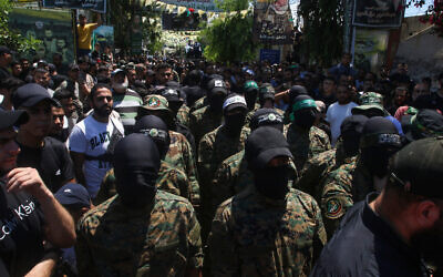 Gunmen attend the funeral of Samer al-Hajj, a commander of the Palestinian Islamist terror group Hamas who was killed a day earlier in an Israeli strike on a vehicle in the southern Lebanese city of Sidon, at the nearby Ein el-Hilweh Palestinian refugee camp on August 10, 2024. (Mahmoud Zayyat/AFP)